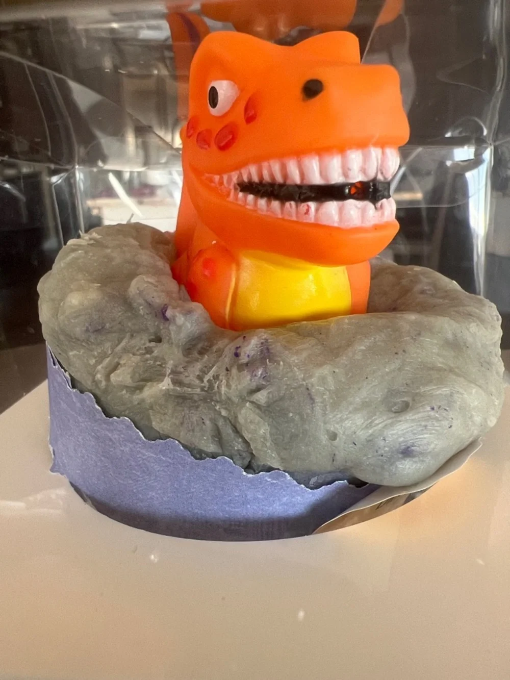 Hand Crafted Orange Dinosaur Bath Toy in Gray Nest